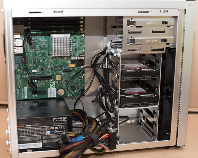 A PC case with various components and loose cables.